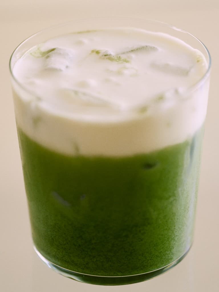 Iced matcha latte with a cream foam top