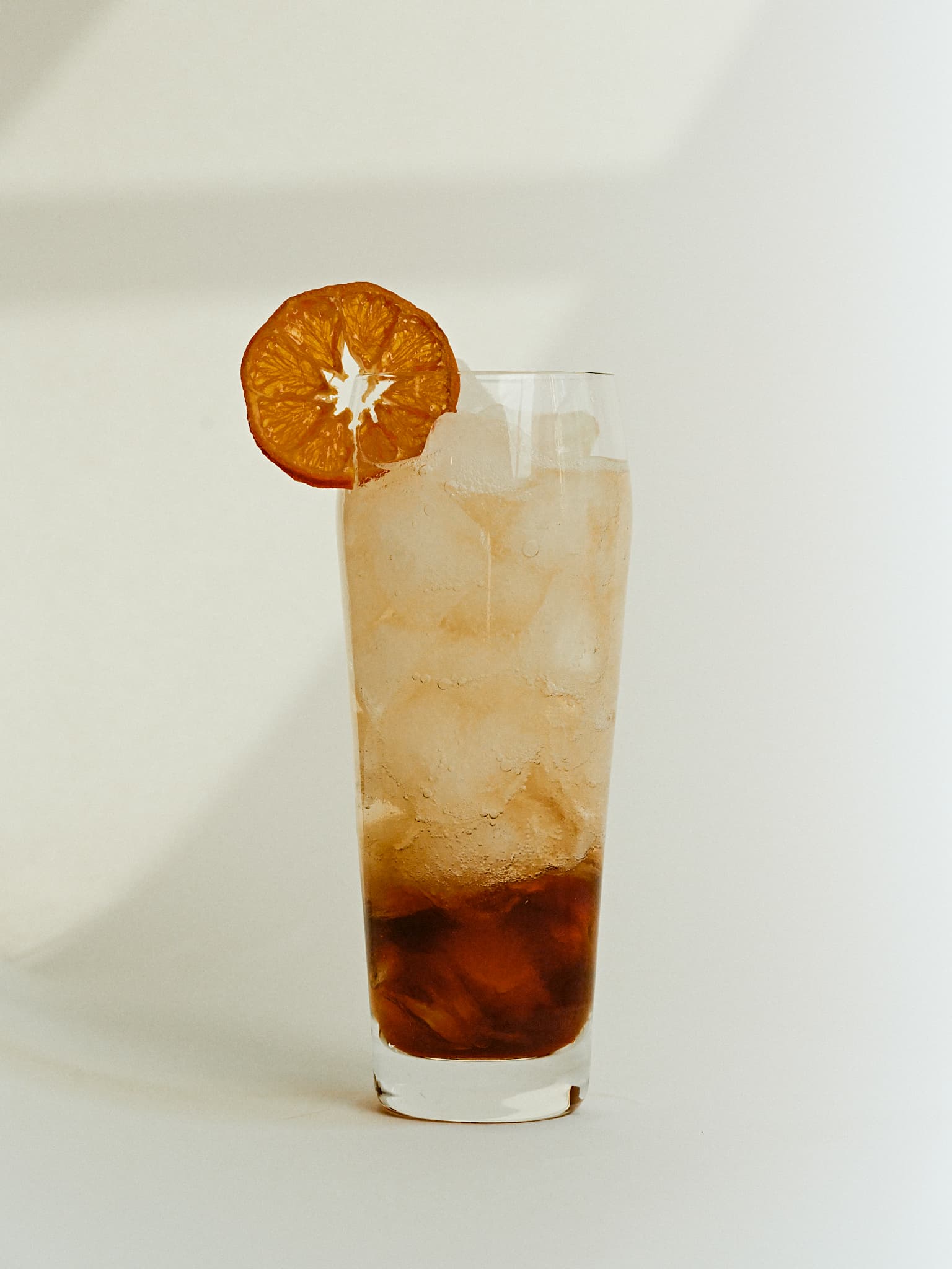 Oolong spritz with ice and a dehydrated orange garnish
